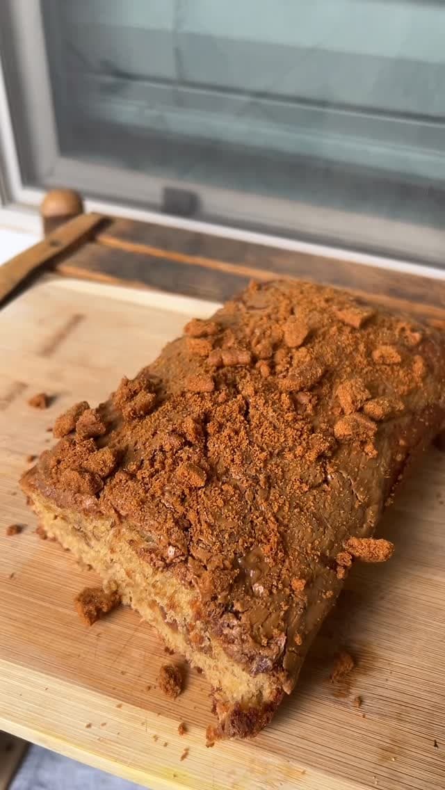 Mya's Biscoff loaf with cookie butter and crumbled biscuits on a wooden board